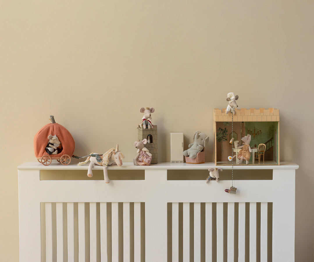 Maileg Small Unicorn stuffed animal styled on nursery shelf with Maileg dolls and play accessories