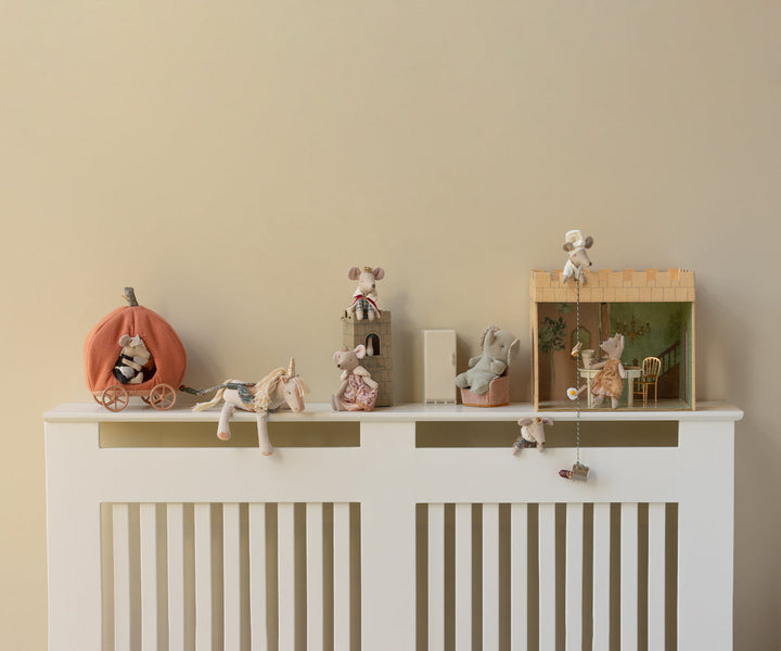 Maileg Small Unicorn stuffed animal styled on nursery shelf with Maileg dolls and play accessories