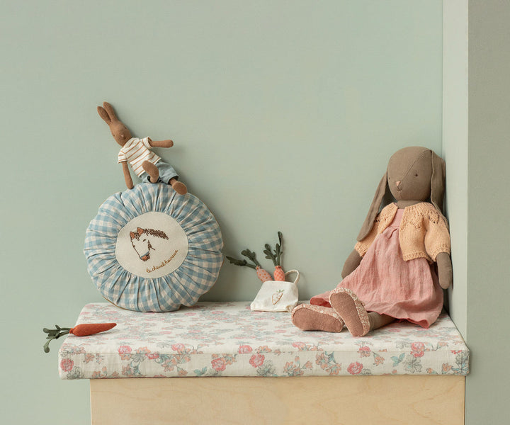 Maileg Cardigan Size 4 Light Rose lifestyle scene with Maileg rabbit dolls on shelf display