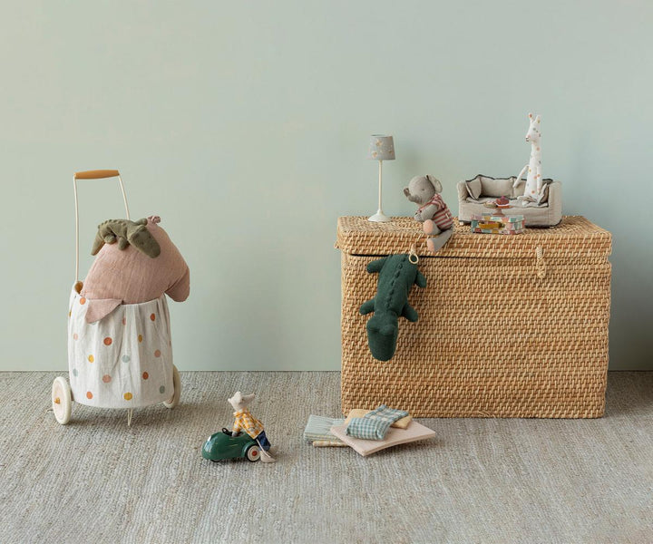 Maileg mini crocodile olive green in room scene with Maileg stuffed animals and wicker storage basket