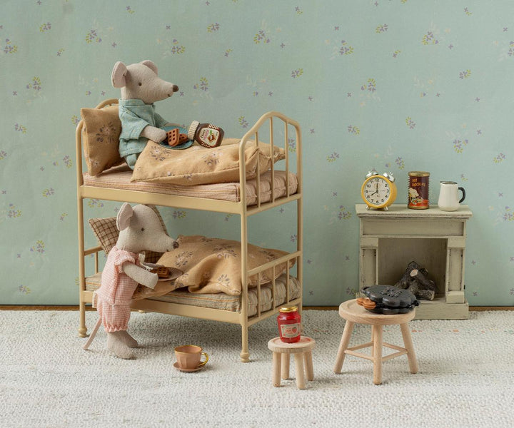This Off White Maileg fireplace lights up a mouse house scene with bunk beds and tiny furniture