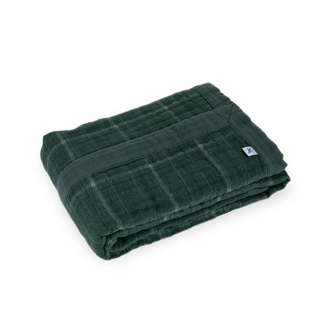 Close-up of Little Unicorn Cotton Muslin Baby Quilt - Evergreen Plaid showing soft, breathable muslin fabric for everyday comfort.