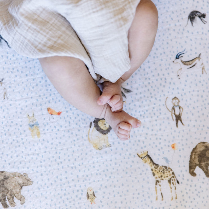 Little Unicorn Cotton Muslin Crib Sheet - Party Animals fitted on mattress, premium organic crib sheets for baby’s room.