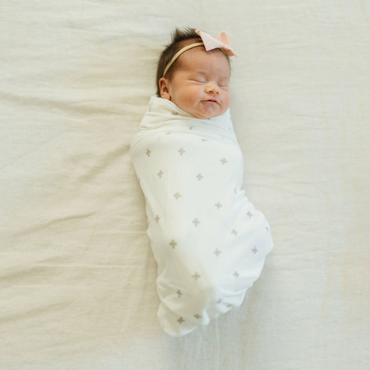 Swaddling muslin blanket in Grey Cross by Little Unicorn, ideal for snug and gentle baby wrapping