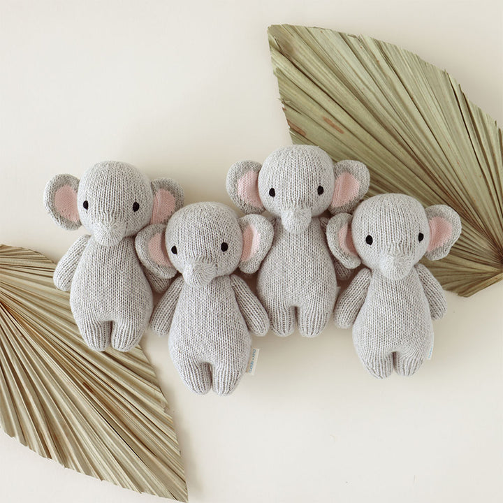 Baby Elephant from Cuddle + Kind sits adorably, a timeless pick for any stuffed animal lover