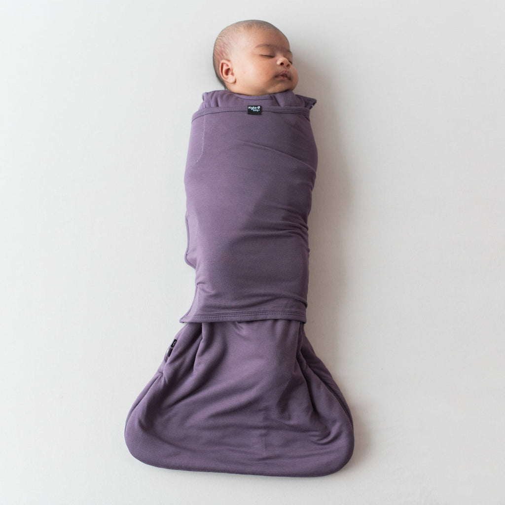 baby warpped in baby sleep bag swaddler by kyte currant