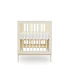 dadada Meringue Soho 3-in-1 Convertible Crib to Toddler Bed Furniture . Light creamy yellow in color. Profile view.