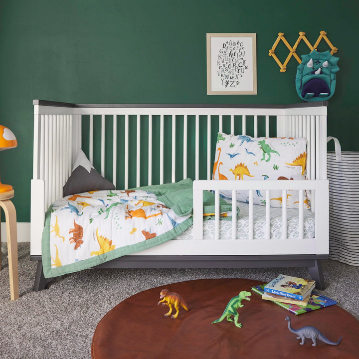 Keep your little one cozy with the Little Unicorn Cotton Muslin Toddler Comforter - Dino Names, a muslin baby blanket.