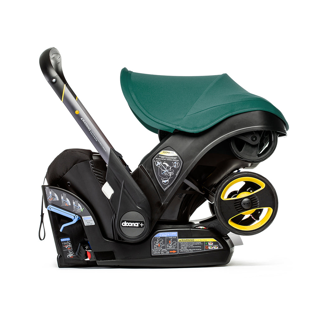 Side view of the Doona Car seat in Racing Green
