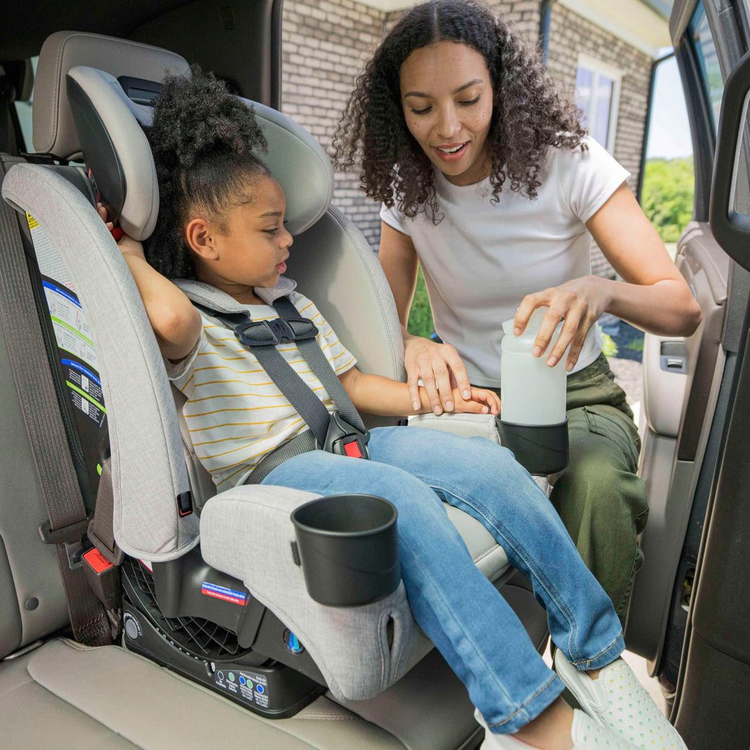 Mom buckling her child into the Britax One4Life Slim car seat in Parchment