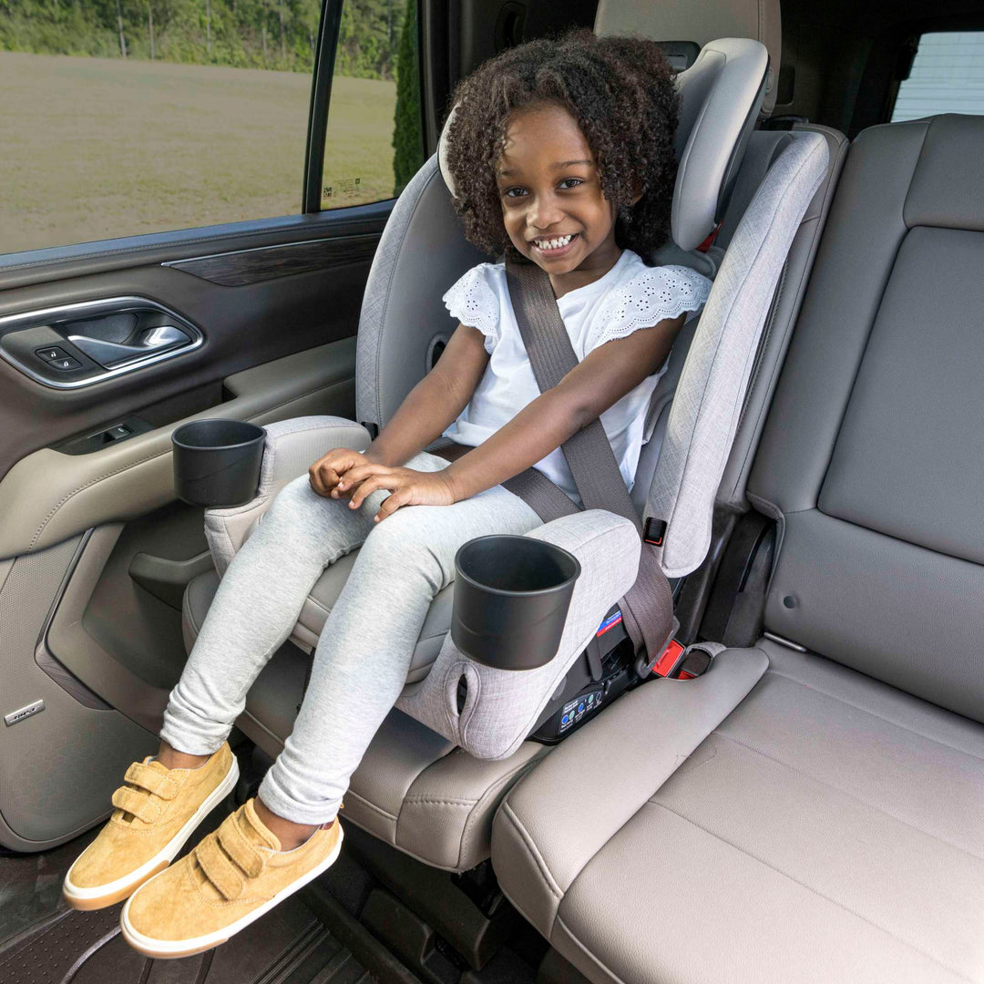 Girl riding in booster mode in the Britax One4Life Slim high-back booster seat, Parchment