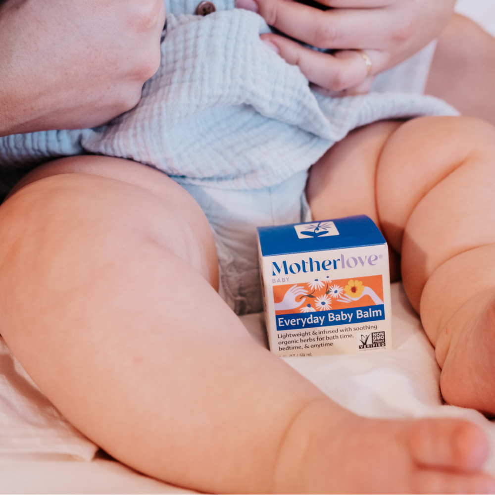 Flat lay of Motherlove Everyday Baby Balm, a gentle herbal formula created as a daily body balm for little ones.