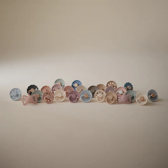 Baby with FRIGG Snowflake Dream natural rubber pacifier - lifestyle photo of latex soother in everyday use