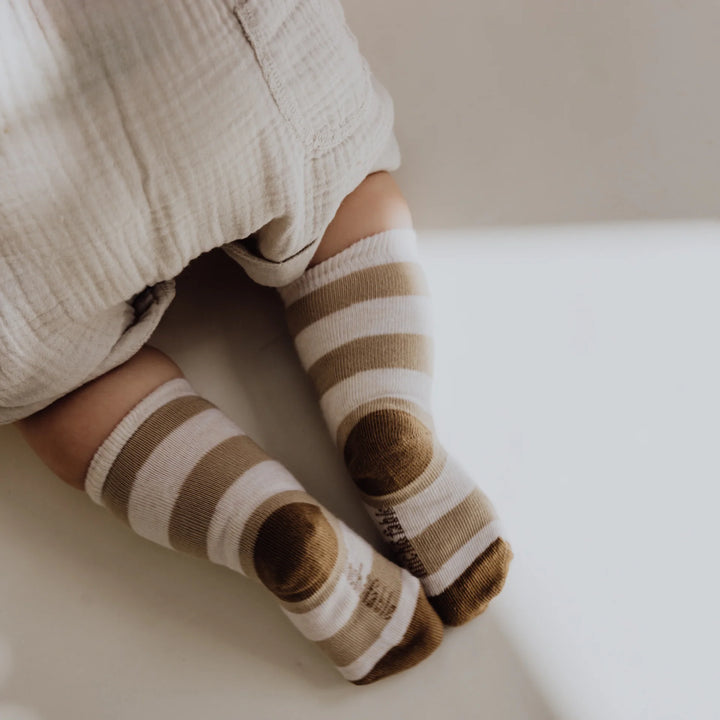 child wearing the finch&fable knee socks in pebble striped socks for babies