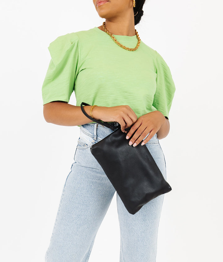 Fawn Design Changing Clutch Bag in Black with Black logo Diaper bag doubles as a clutch or hand bag and has a handle 