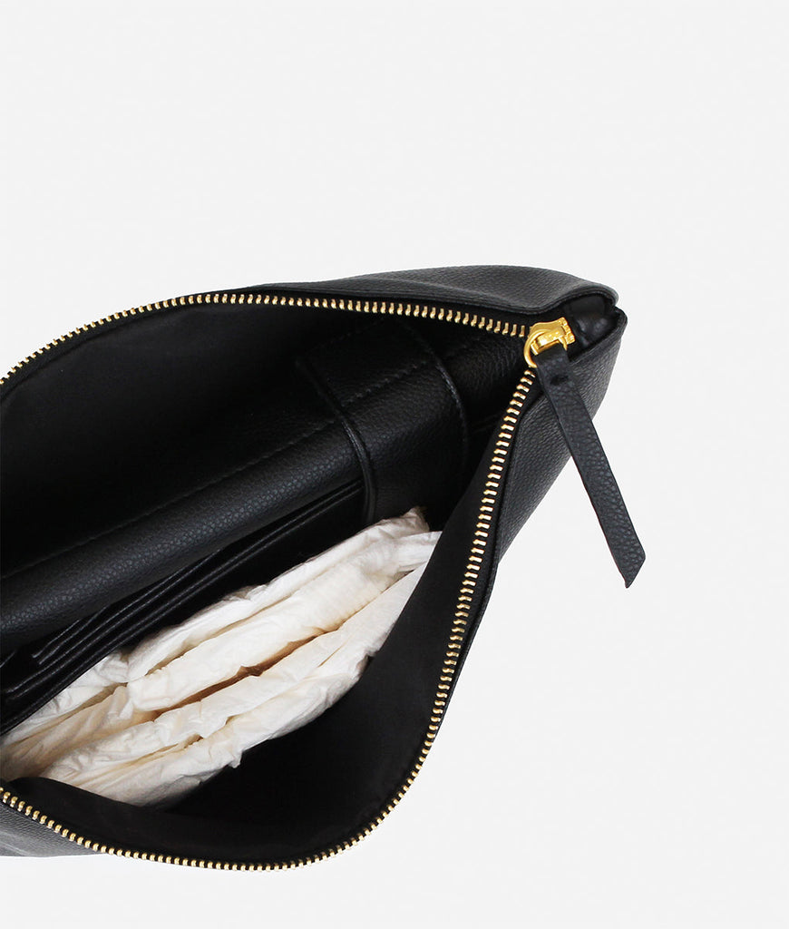 Inside details of the Fawn Design Changing Clutch Bag in Black, a Diaper Bag that doubles as a cute going out bag with a matching faux leather changing mat