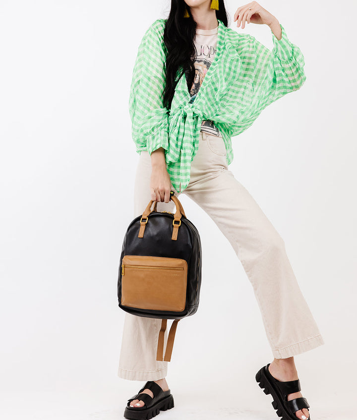 Fawn Design Diaper Pack in Black and Tan a two-tone diaper bag featuring a double-chamber design