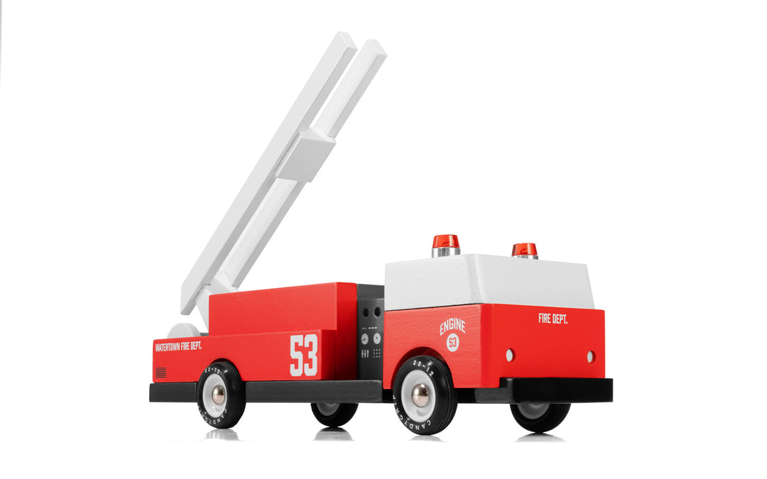 A dynamic angled shot shows the Plantoys Ladder 53 Fire Truck ready for action, perfect for families shopping toy cars for kids.