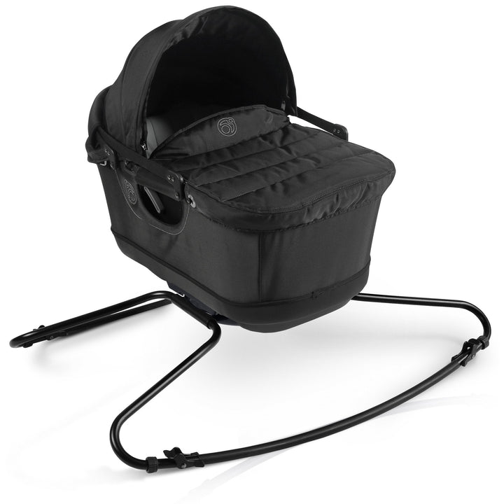 A side profile of the Orbit Baby G5 Travel Bassinet Black reveals its elegant frame and the best bassinet for baby use.
