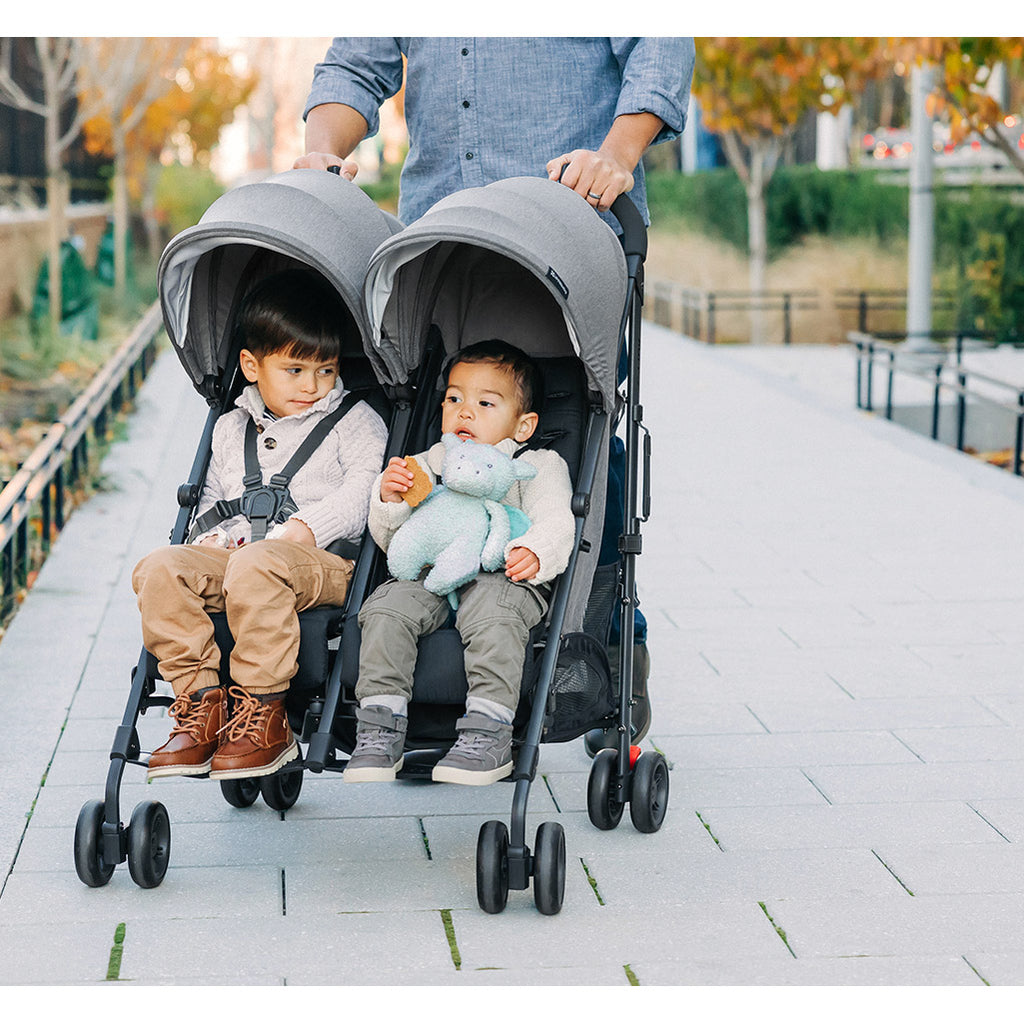 dad pushing kids in uppababy g-link twin stroller