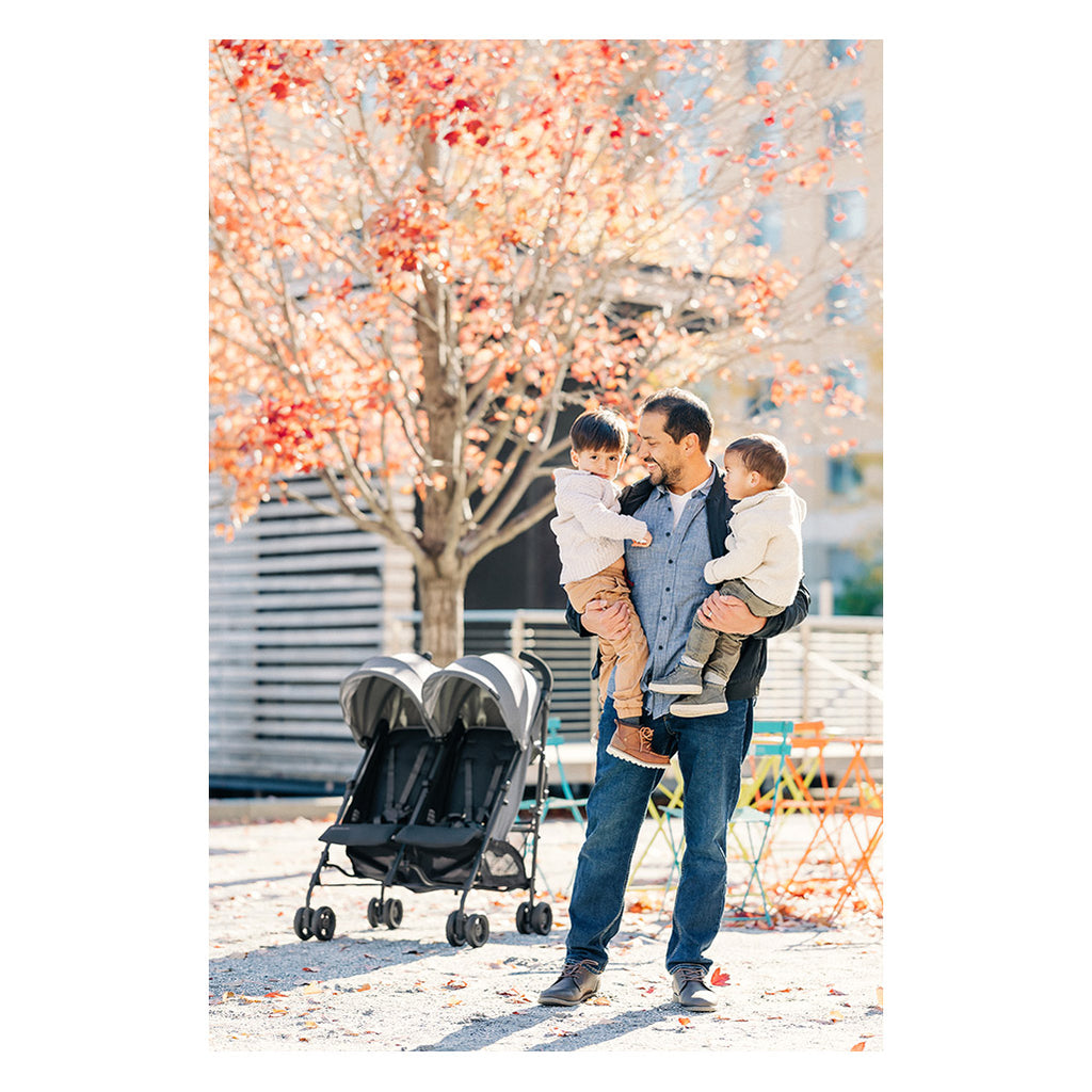 family outside in fall with uppababy g-link twin stroller