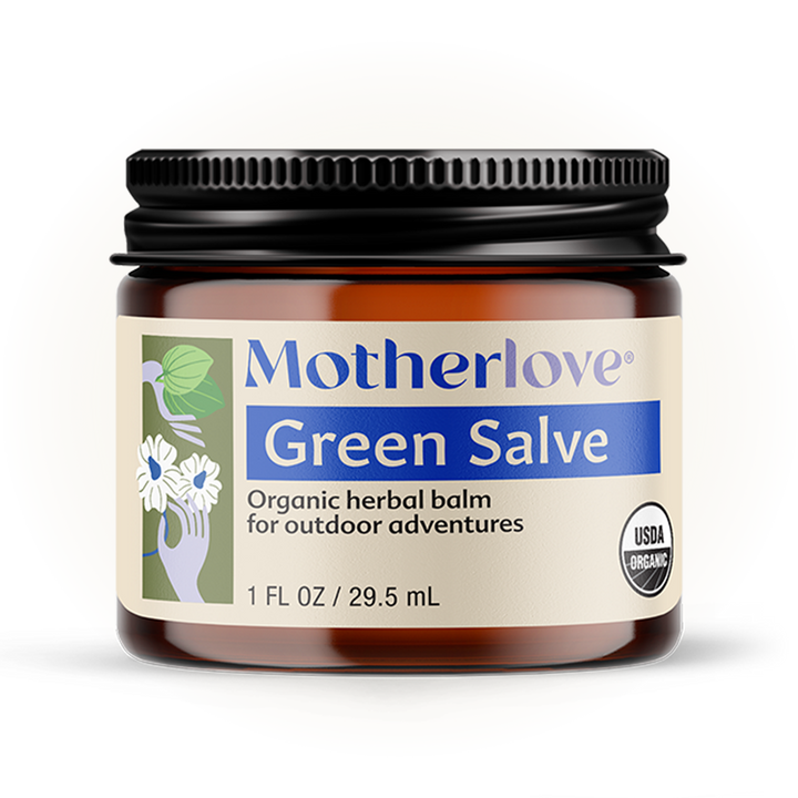 Soft light highlights Motherlove Green Salve, a nourishing skin balm that calms and hydrates dry, irritated skin.