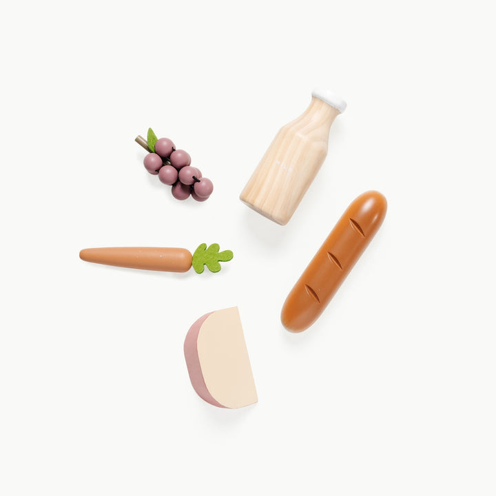 Close up of play food pieces from the Grocery Set, including grapes, bread, and milk, by Gathre