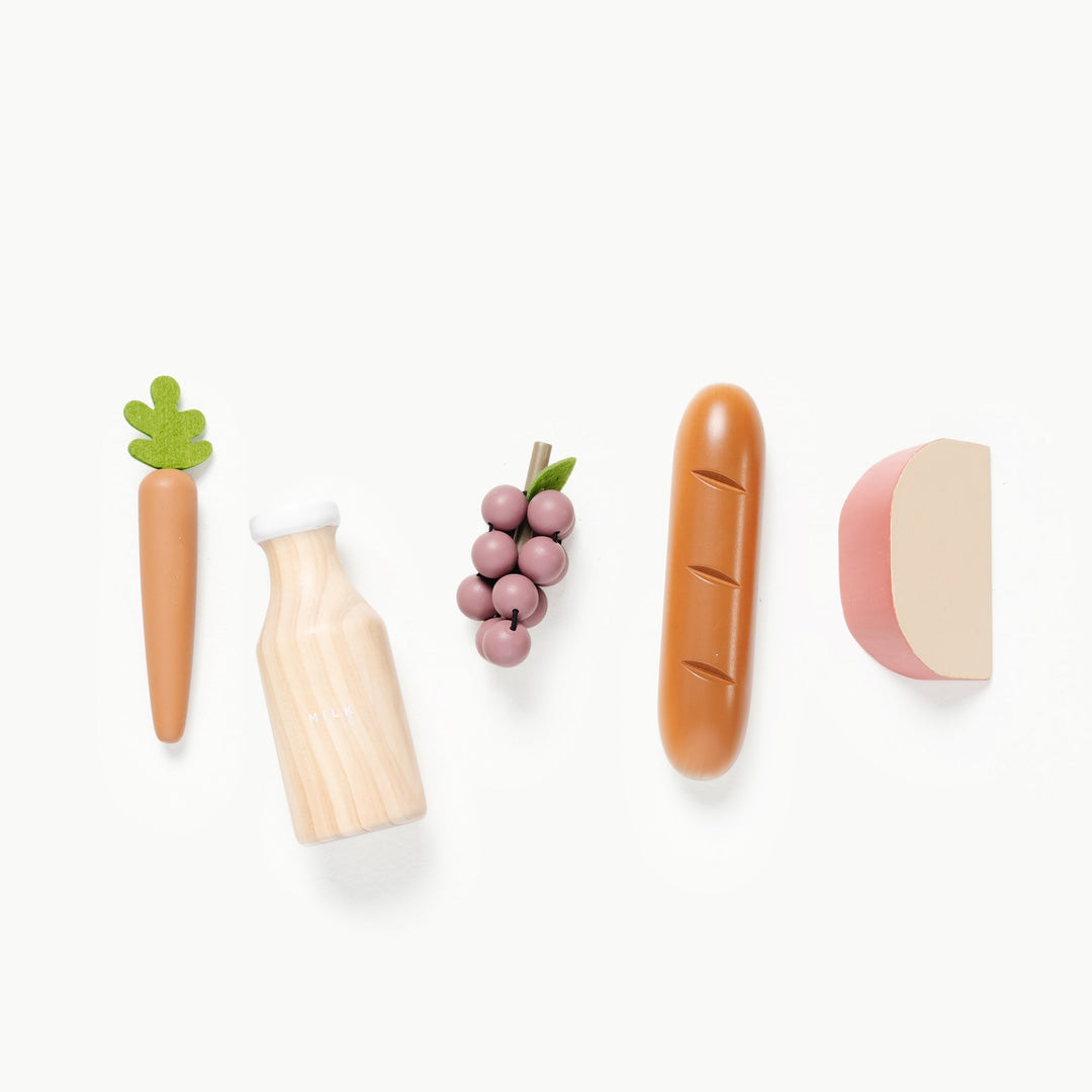 Wooden and felt grocery set by Gathre featuring a milk bottle, carrot, grapes, baguette, and cheese