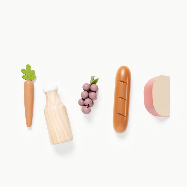 Wooden and felt grocery set by Gathre featuring a milk bottle, carrot, grapes, baguette, and cheese