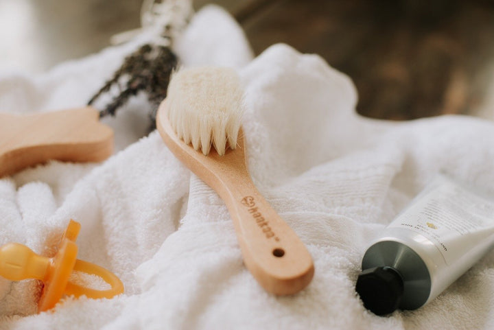 glamour shot of haakaa natural goat wool baby hair brush