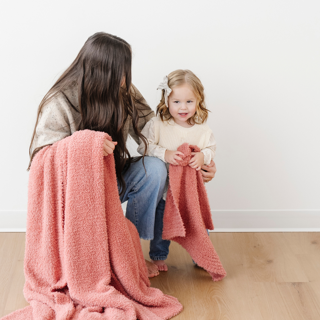 SaranoniÕs BAMBONI¨ Mini Blanket in Hibiscus adds warmth and style, one of the best toddler blankets for every season.