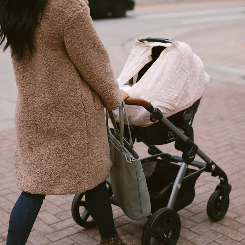 Elegant cross pattern on the Little Unicorn Cotton Muslin Car Seat Canopy - Taupe Cross, a timeless car seat accessory for parents.