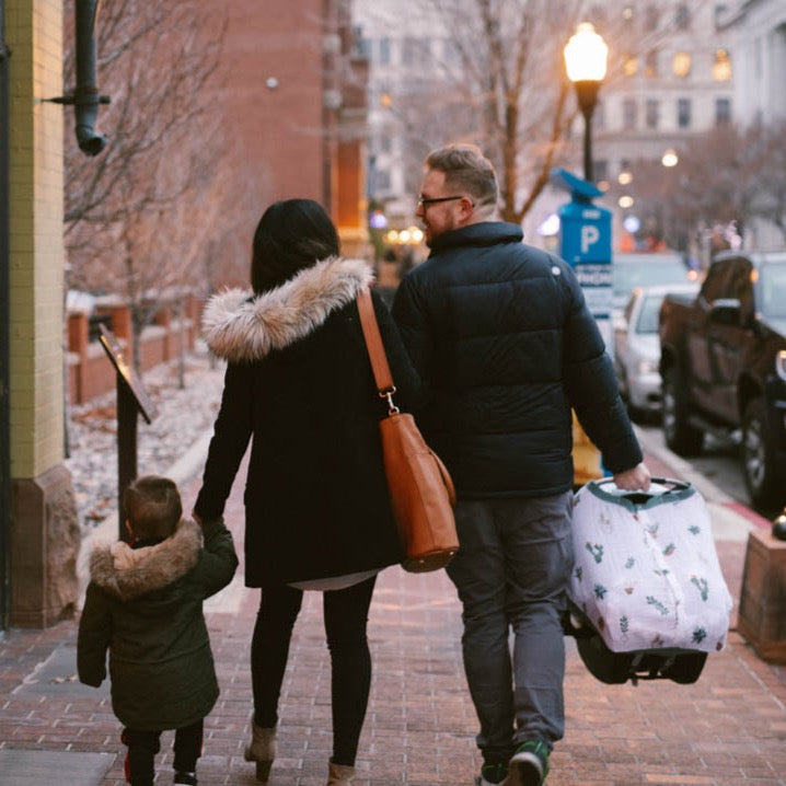 Little Unicorn Cotton Muslin Car Seat Canopy - Prickle Pots displayed on a car seat, offering cozy shade and modern desert-inspired design.