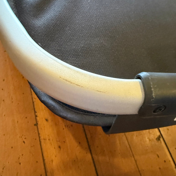Close-up of scuffs on the silver frame of an open box UPPAbaby RumbleSeat V2+ in Bryce from transit