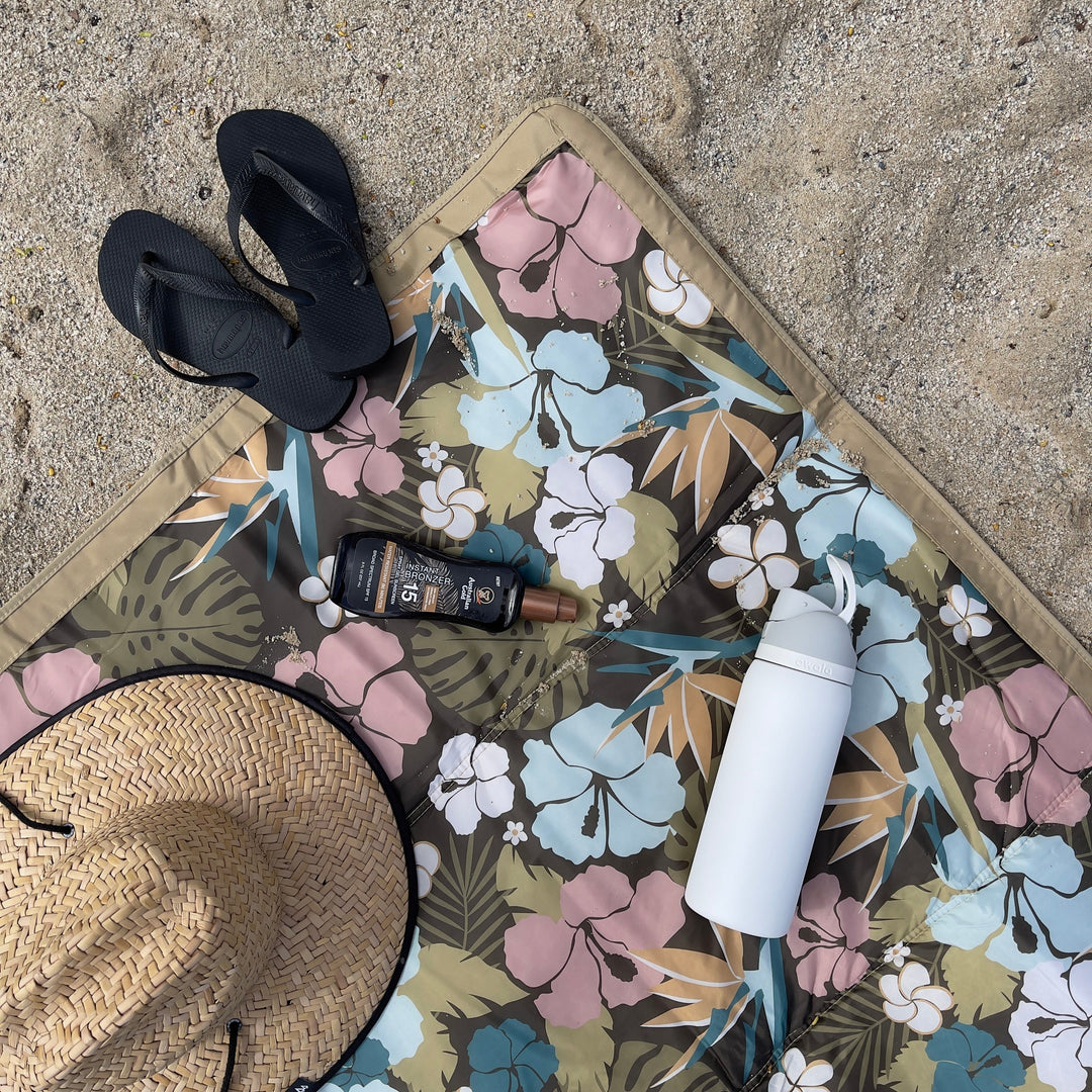 Set up on sand, Little Unicorn Outdoor Blanket - Hibiscus functions as a versatile outdoor blanket waterproof for all activities.