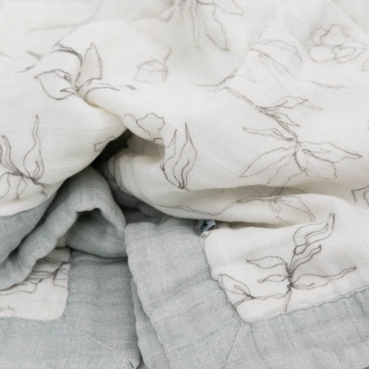 Close-up of Little Unicorn Organic Cotton Muslin Baby Quilt - Pencil Floral, highlighting the fine texture of these gentle muslin baby blankets.