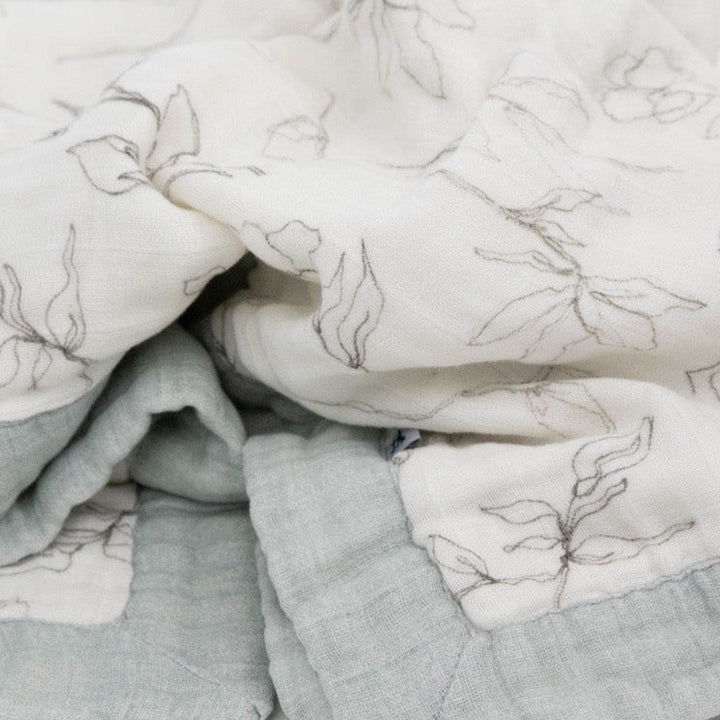 Close-up of Little Unicorn Organic Cotton Muslin Baby Quilt - Pencil Floral, highlighting the fine texture of these gentle muslin baby blankets.