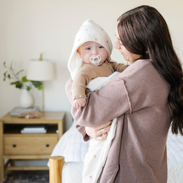 Post-swim warmth comes from Saranoni Hooded Towels in Ice Cream, a baby beach towel toddlers love.