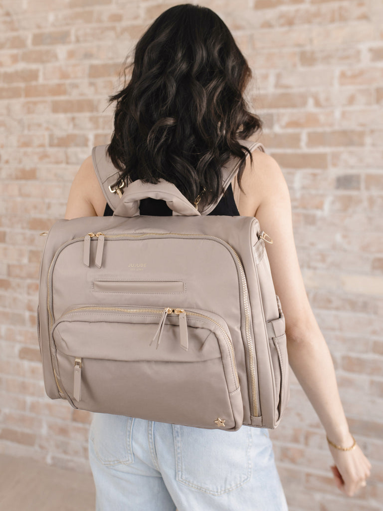 JuJuBe Diaper Satchel in Taupe offering three ways to carry: satchel backpack or messenger