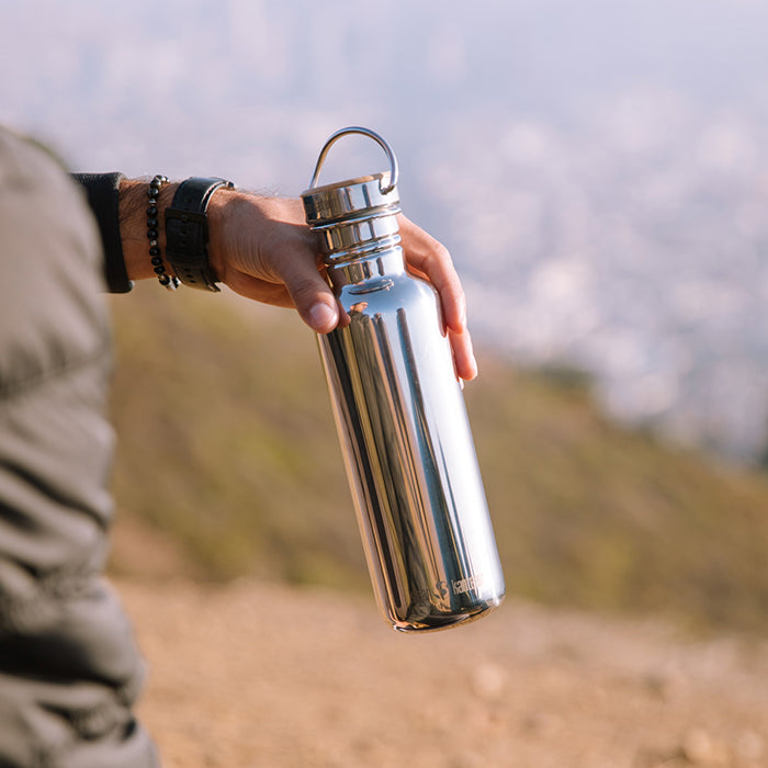 Handheld view of Klean Kanteen 27oz Reflect with Bamboo Cap in Midnight Sky, crafted from natural materials