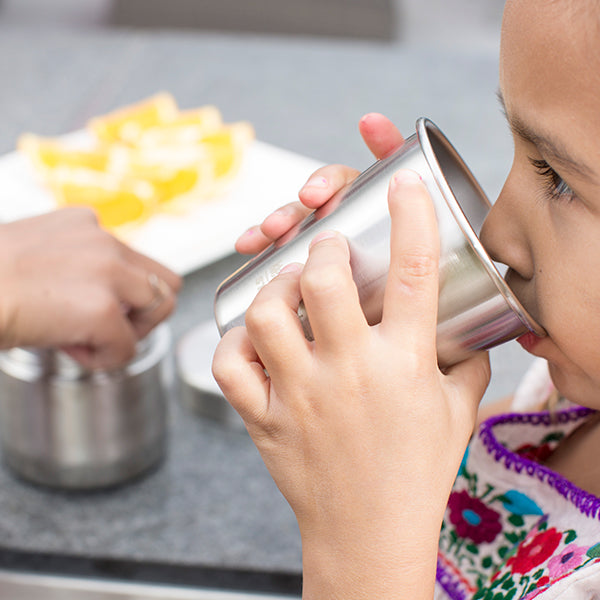 Girl enjoying Klean Kanteen 10oz Cup, made from stainless steel and for safe drinks.