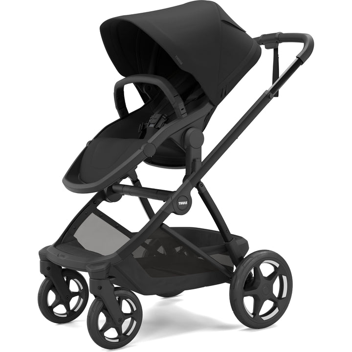 Black on black Thule Charm Stroller stroller w/ newborn insert, stroller seat, three-quarter view
