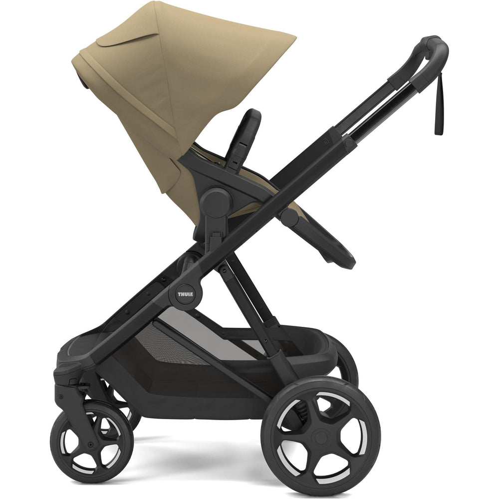 Faded khaki on black Thule Charm Stroller reversible seat stroller, parent-facing seat, side view