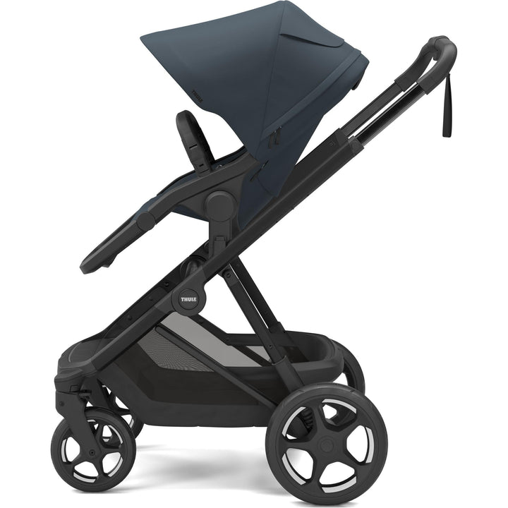 Premium baby stroller - Thule Charm Stroller, world-facing seat, side view, Darkest blue on black