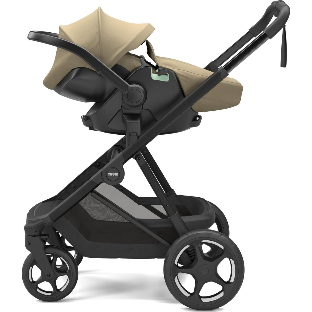 Thule Charm Stroller in Faded khaki on black, with Thule Maple car seat and boot cover | stroller w/ newborn insert