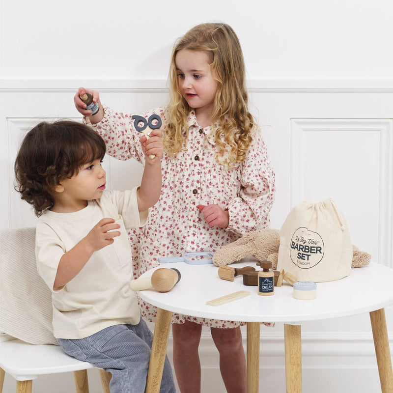 Le Toy Van Barber set being used for pretend play by kids encourages social skills and cooperation