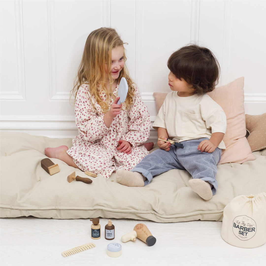 Kids sharing the Le Toy Van barber set for pretend play