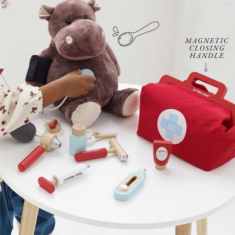 child pretending to be a doctor with Le Toy Van doctor kit