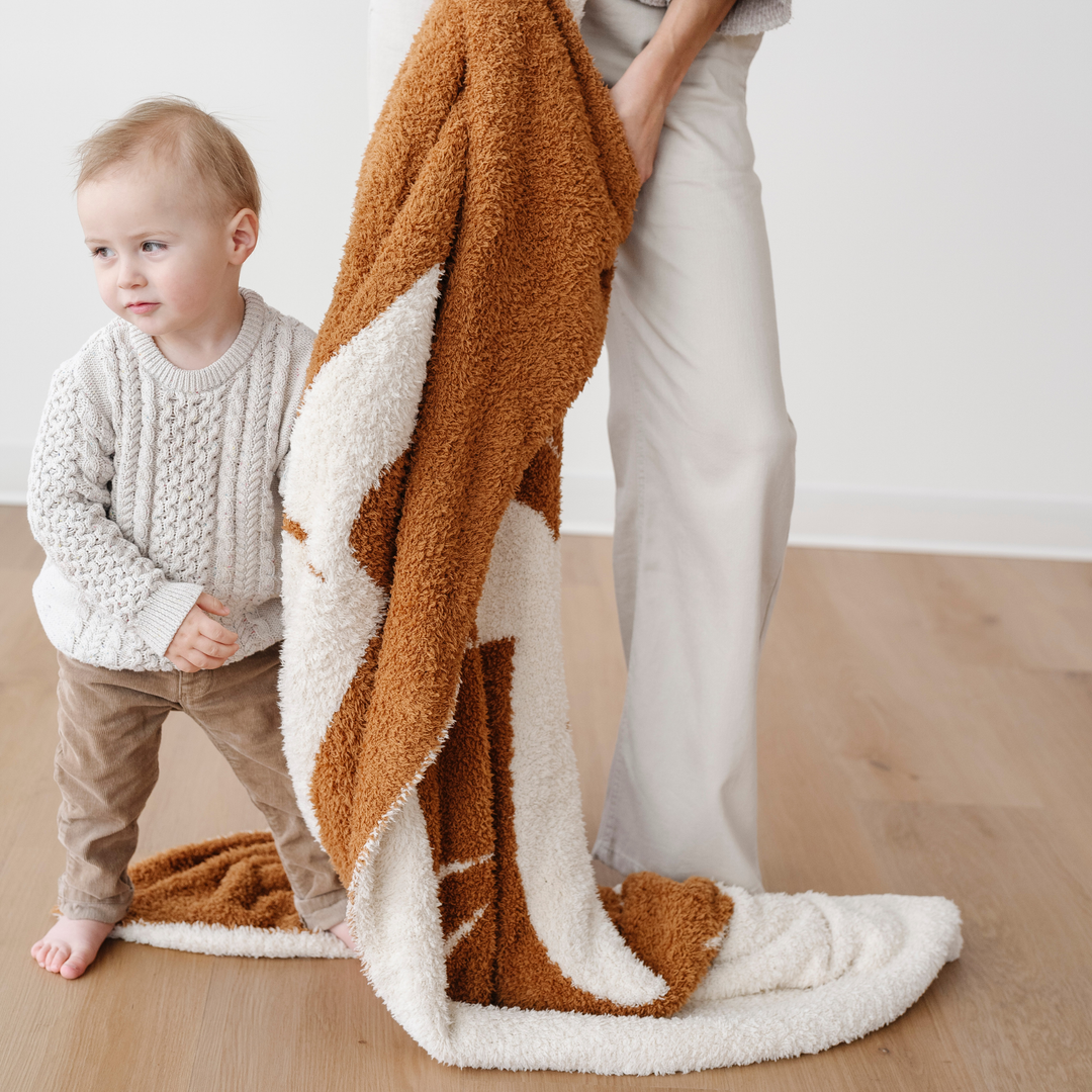 Soft, stylish, and snuggly Ñ the Saranoni Double-Layer BAMBONI¨ Mini Blanket in Lion is loved as one of the best toddler blankets.