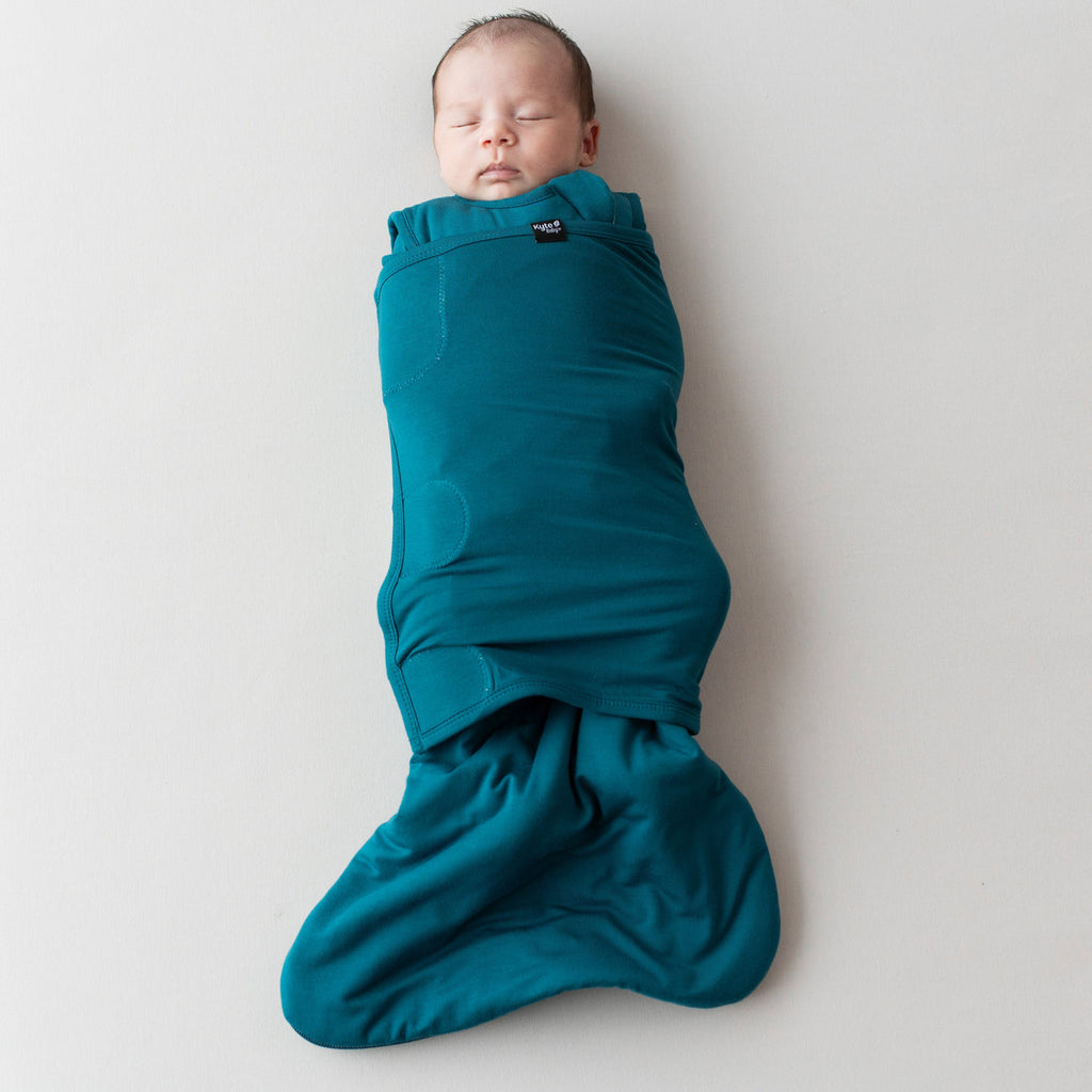 infant sleeping in Kyte Baby loch sleep bag swaddler tog 1